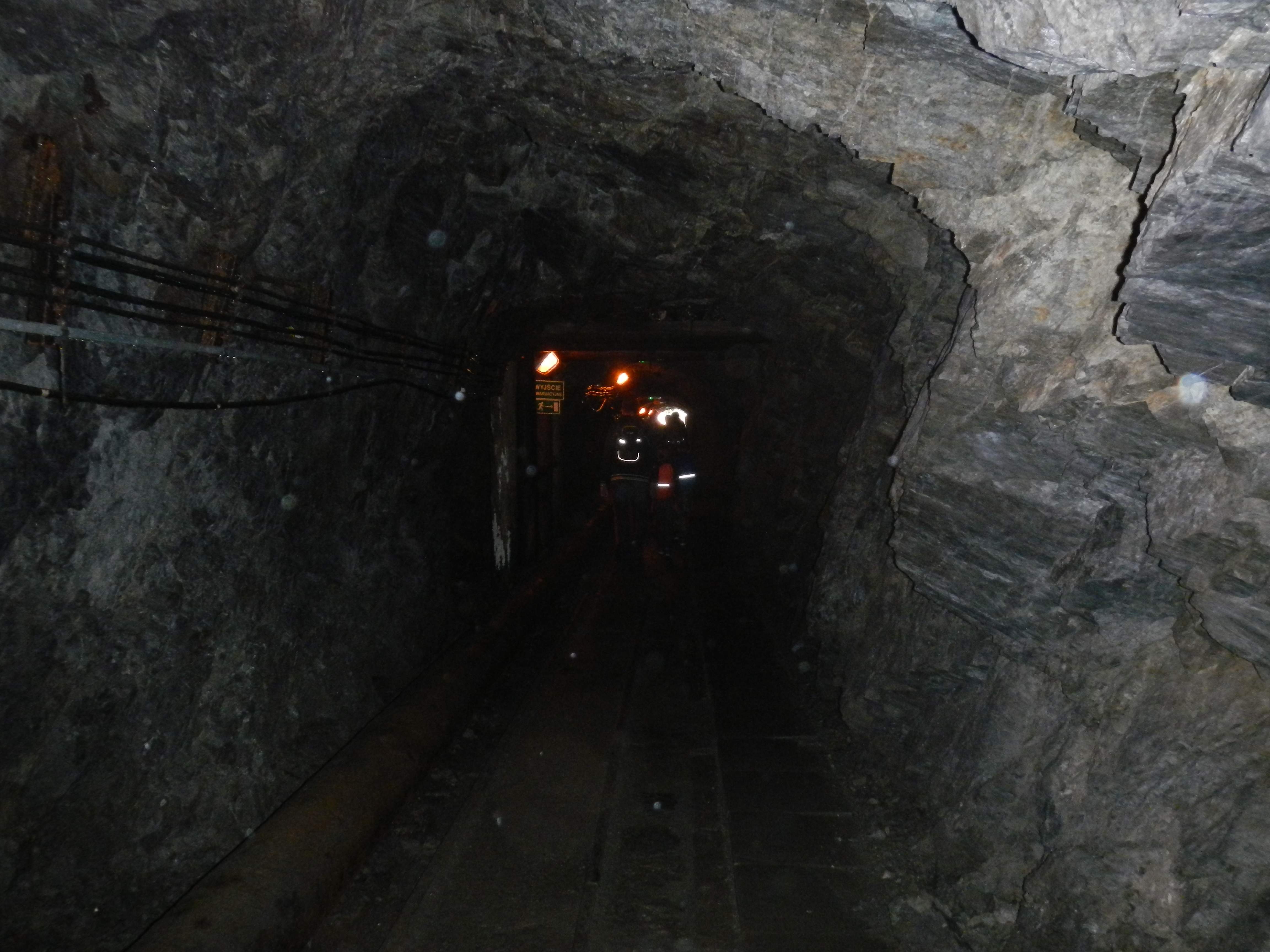 Światełka w ciemnym górniczym korytarzu w zalanej części sztolni Gertruda