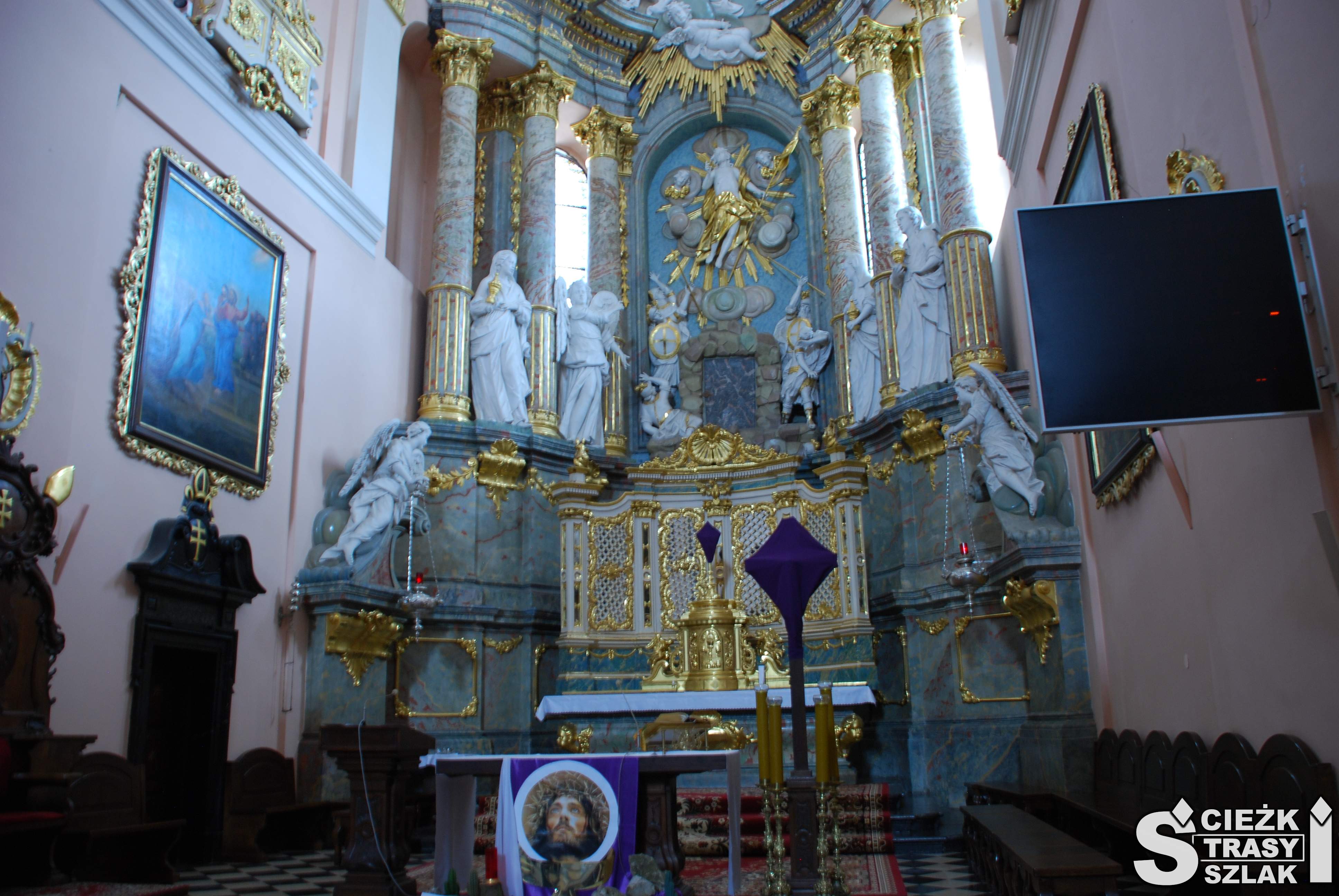 Ołtarz główny z zasłoniętym krzyżem przed Niedzielą Palmową we wnętrzu bazyliki w Miechowie z repliką Grobu Bożego